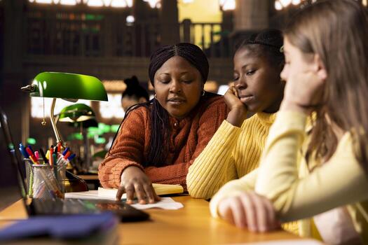 Female teacher assisting pupils with class homework and mentoring them, providing academic instruction and support to help them pass their school assignments. Tutor lecturer gives private lessons. photo