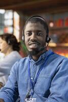 Portrait of smiling call center operator talking in audio headset mic, providing step by step guide to customer. Upbeat customer center employee speaking in headphones microphone, providing technical solutions photo