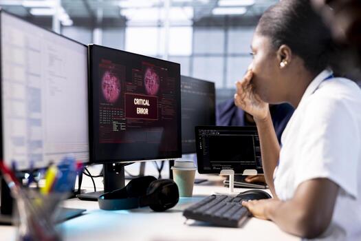 Anxious cybersecurity employee panicking while monitoring security incidents affecting server hub network system, worrying after seeing critical error affecting infrastructure racks photo