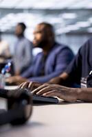 Data center worker typing on keyboard, using programming languages to construct algorithms and build applications. Close up of server hub IT employee writing and optimizing code photo