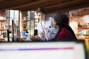 Call center manager evaluating new company intern performance by judging customers satisfaction. Customer service department supervisor overseeing new employee technical onboarding photo