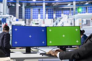 Solar panels plant engineer overseeing energy consumption using isolated screen PC. Photovoltaics facility employee ensuring optimal use of manufacturing resources using mockup computer monitors photo