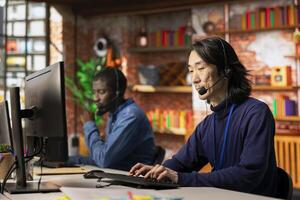 Team of call center agents cooperating to provide step by step guidance to customers, talking in headset mic. Coworkers doing customer support job working together, walking clients through fixes photo