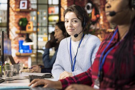 Portrait of cheerful call center manager evaluating company intern performance by judging customers satisfaction. Joyous customer service department supervisor overseeing new worker onboarding photo