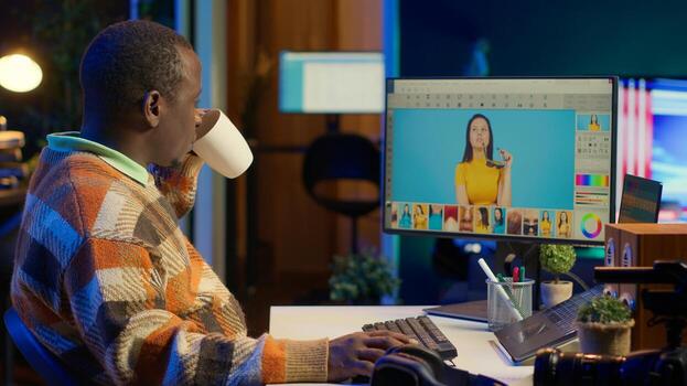 Skilled male designer using editing software on dual monitors in organized workspace, symbolizing the future of digital design and remote work. Digital art photo retouching. Camera A.