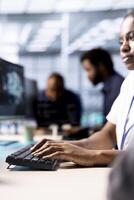 Programmer in server room using artificial intelligence technology for increased productivity in startup workplace. Data center worker implementing AI driven predictive analytics solutions photo