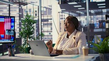 African american CEO reviews data analytics on a hologram reflection, using artificial intelligence futuristic interface for a business project. Director uses hi tech illustrations. Camera B. photo
