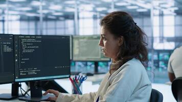 Portrait of smiling technician programming in AI data center used for machine learning training. Cheerful IT expert running code to upgrade artificial intelligence tech, camera A photo