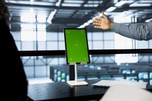Engineers using isolated screen tablet in data center, managing server virtualization. Workers using mockup device in server room, sustaining long term infrastructure reliability photo