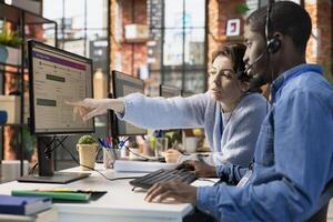 Call center agents collaborating to solve problem for customer, tracking lost shipments in office. Customer center colleagues working together using software to locate clients packages photo
