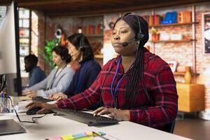 Team of multiethnic call center agents in workplace helping customers regain access to accounts. Multiracial workers in diverse customer center assisting clients needing help resetting password photo