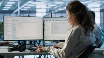 IT professional in server hub ensuring valuable data remains shielded from potential threats using PC. Employee safeguarding data center against unauthorized access and vulnerabilities, camera A photo