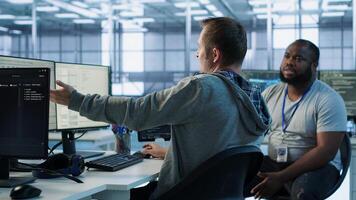 Manager admonishing programmer after making error damaging high tech data center. Supervisor scolding IT staff member after doing mistake in server room affecting supercomputers, camera A photo
