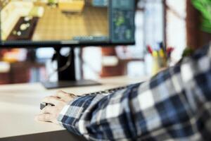 Interior designer uses 3D modeling program, selecting furniture from catalog, dragging objects across floor plan. Close up of man in home office using CAD software, arranging layout, positioning items photo
