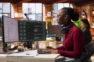 IT engineer in startup office using large language model on computer to get help with coding project. IT expert interacting with AI LLM chatbot on PC in software development business company photo