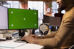 Startup entrepreneur using chroma key PC to do research, looking to grow value of company. Close up of venture business manager using isolated screen computer, developing innovative growth strategy photo