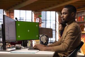 Programmer coding in startup office using isolated screen PC, building scalable solutions for businesses. AI industry startup technician leveraging machine learning technology on chroma key computer photo
