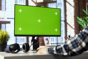 Teleworker in living room office using green screen PC to answer emails from business associates. Close up of remote worker typing on mockup device keyboard, solving tasks in apartment photo