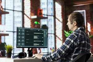 Man in apartment using software on computer integrating language model functions and processing user input. Person in home office speaking with AI chatbot producing text output photo