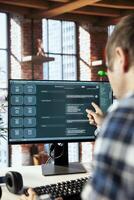 Teleworker in home office requesting aid from large language model chatbot engaging in humanlike interaction. Remote worker using artificial intelligence LLM handling user requests photo