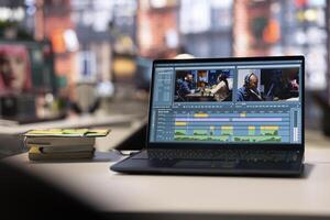Professional agency setup for cinematic footage creation and editing. Empty workspace with a laptop used by makers to create artistic montage, visual movie content and design. photo