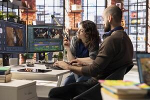 Creative team of editors collaborating on a movie montage project, using AI chatbot and post production software for color grading. Young couple uniting forces for content. photo