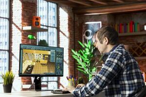 Interior designer sitting at desk using 3D modeling software on computer, moving furniture assets. Architectural designer aligns items into position, saves configuration for client approval photo