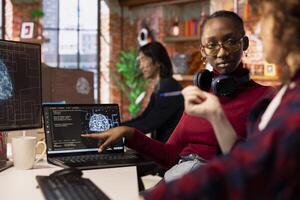 Startup engineers leveraging artificial intelligence tech in workspace to gain competitive edge. Silicon Valley company IT professionals cooperating to do rapid technological advancement photo