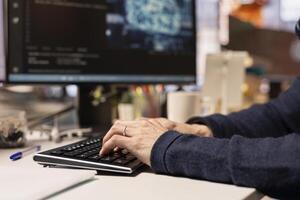 Startup programmer leveraging artificial intelligence tech in office to gain competitive edge. Close up of AI specialist typing on PC keyboard, working on rapid technological advancement photo