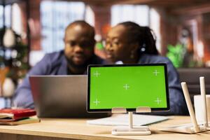 Black couple tries to fix an ongoing Wi Fi problem by rebooting their modem next to copy space display, troubleshooting connection errors and testing different network configurations. Signal loss. photo