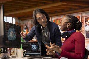 AI startup office chief technology officer overseeing programmer building application. Senior manager assisting worker in artificial intelligence software development agency, offering advice photo