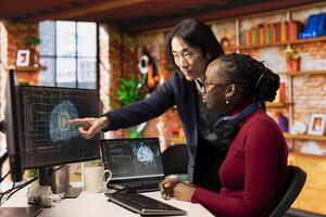 CTO supervisor in artificial intelligence focused startup overseeing worker designing, coding and debugging applications. Team leader supervising employee doing code testing and quality assurance photo