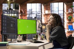 Adult types prompts on a PC to receive responses next to mockup, working with artificial intelligence for efficiency. Advanced chatbot demonstrates efficient support and automation. photo