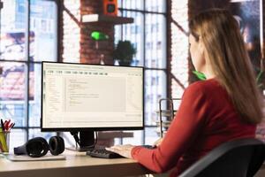 Woman engaging with an intelligent AI chatbot to complete work related tasks, working from her loft apartment. Technology showcases machine learning and smart algorithms for productivity. photo