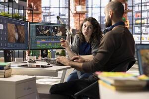 Creative couple working together on editing software for movie making, using AI powered models to create the perfect montage. Editors team in post production media industry. photo