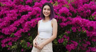 Thai Woman with Black Hair in White Top Surrounded by Blooming Pink Garden photo