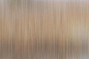 Blurred light brown background with vertical streaks photo