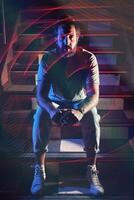 Man sitting on stairs in nightclub photo