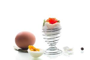 Quick and easy breakfast.delicacy with red caviar and boiled egg for breakfast, isolated on white background photo