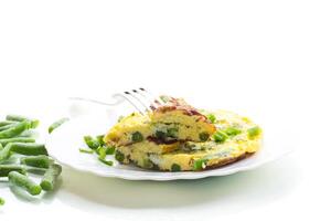 Dietary delicious breakfast.Egg omelette with herbs and vegetables isolated on white background photo