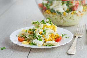 Diet for dinner.Chinese cabbage salad with squid, eggs, tomatoes and other vegetables photo