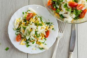 Quick and easy breakfast.Chinese cabbage salad with squid, eggs, tomatoes and other vegetables photo