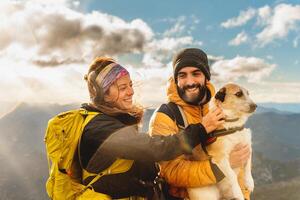 people trekking in the mountains with pet enjoying the breathtaking views photo
