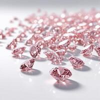 Close-up of pink diamonds scattered on a white glossy surface. Image for jewelry business photo