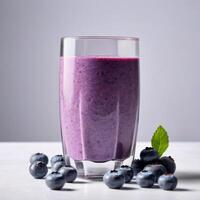 Glass of blueberry smoothie with fresh berries, copy space. Close-up food image for use in product design photo