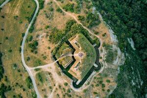 Fort Gorazda on the top of a mountain among green trees. Montenegro. Top view photo