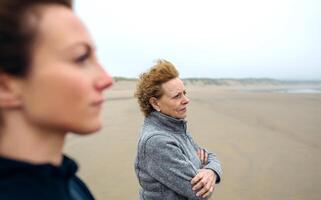 Two women looking at sea photo