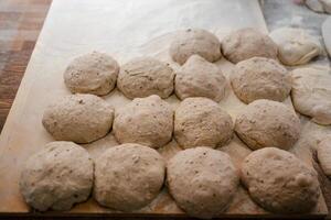 Loaf-shaped bread dough on the table photo