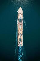 Huge cruise ship with a swimming pools floats on the sea. Top view photo