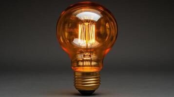 Glowing amber Edison light bulb on dark background. photo